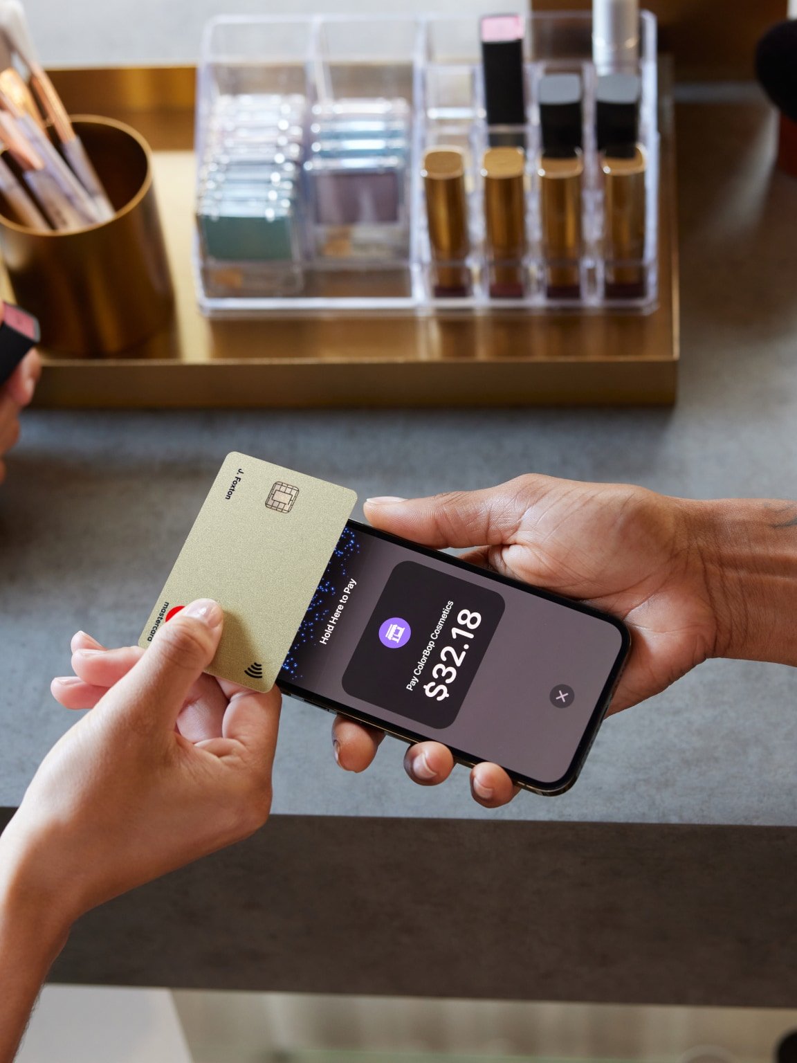 A customer taps a card on an iPhone